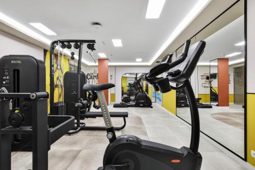 a gym with treadmills and elliptical machines at Hotel Riu Concordia in Playa de Palma