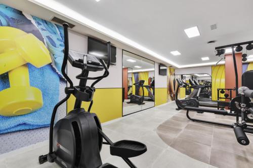 a fitness room with treadmills and a gym at Hotel Riu Concordia in Playa de Palma
