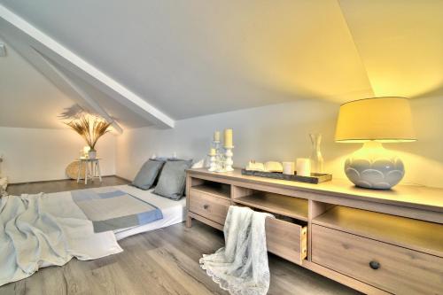 a bedroom with a bed and a table with a lamp at Dida moj in Senj