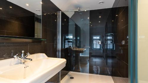 a bathroom with a sink and a shower at The Farm House in West Malling