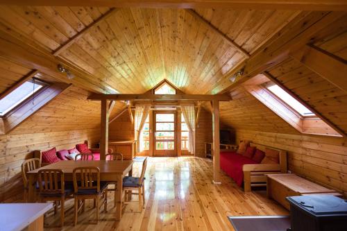 a room with a table and chairs in a cabin at Ranch Jelov Klanac in Rakovica