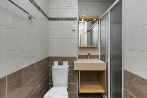 a bathroom with a toilet and a sink at Hotel Djerdap in Kladovo