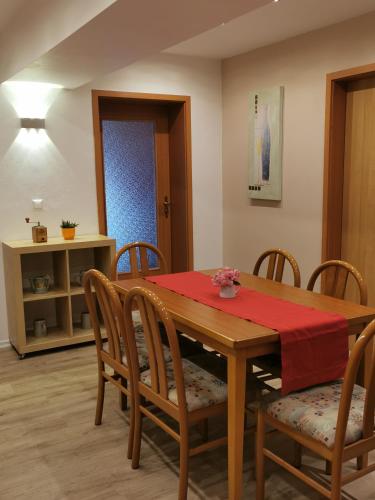 a dining room with a wooden table and chairs at Hotel Mainperle in Wertheim