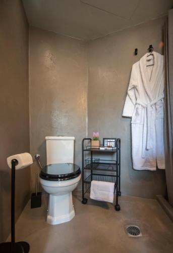 a bathroom with a toilet and a towel rack at Urban Sea View Lofts #3 in Chalkida