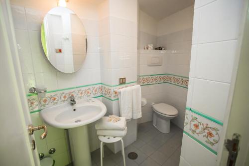 a bathroom with a sink and a toilet and a mirror at La Piazzetta in Amalfi