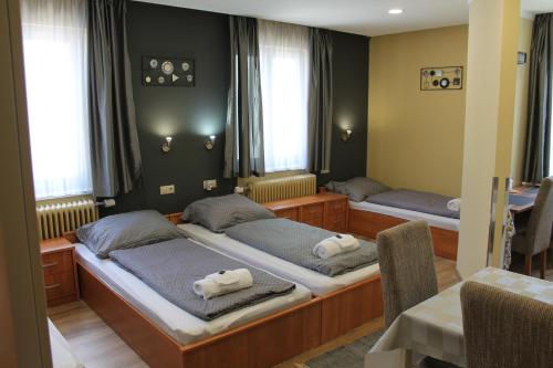 a bedroom with two beds with towels on them at Kirschbaum Apartment in Murau