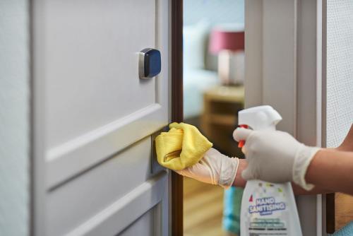 a person is cleaning a door with a cleaning glove at Novotel Chennai OMR in Chennai