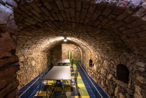 a stone tunnel with a table and chairs in it at Dům Přátel Pavlova in Pavlov