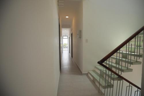 a hallway with stairs in a building with a door at M Hotel Đà Lạt in Da Lat