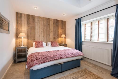 a bedroom with a large bed and a window at The Sail House in Wighton