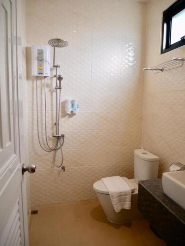 a bathroom with a shower and a toilet and a sink at Look at Home Lamphun in Lamphun