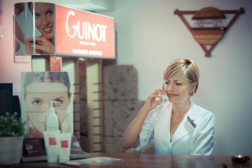 a woman brushing her teeth in front of a mirror at House of Dracula Hotel in Poiana Brasov