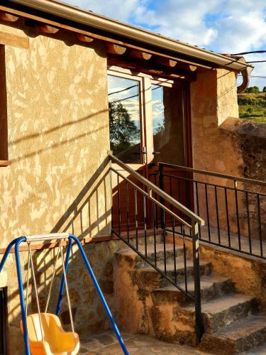a staircase leading up to a house with a window at La Fuente del Poval in Caballar