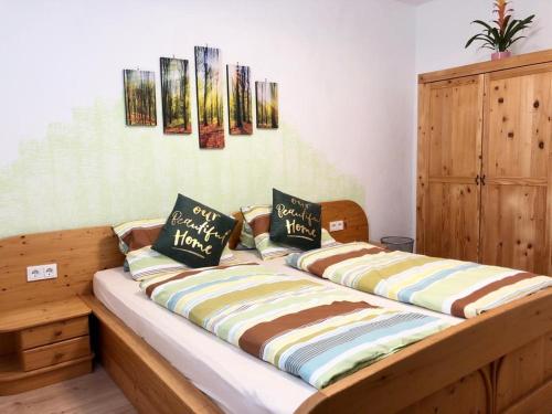 a bed with two pillows on it in a room at Biohof Obereibensteiner in Kaltenberg