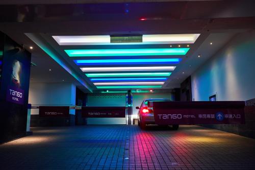 a car parked in a parking garage with a lit ceiling at Tango Motel in Taipei