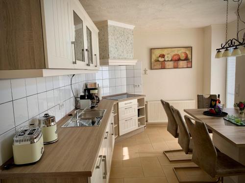 a kitchen with a sink and a counter top at Ferienhaus Casa Markus Kalkar in Kalkar