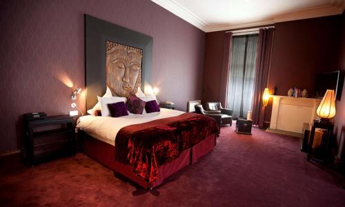 a hotel room with a bed with a head on it at Carmelite Hotel; BW Signature Collection in Aberdeen