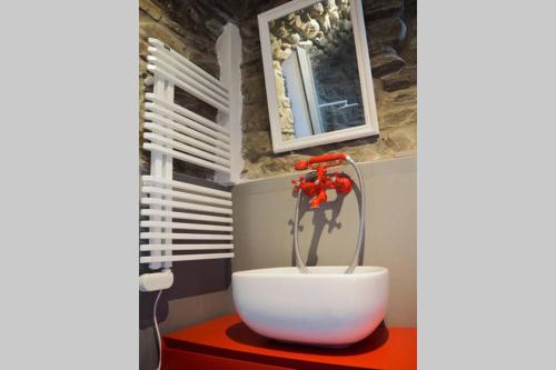 a bath tub in a bathroom with a faucet at Casa Oliva Cinque Terre in Manarola