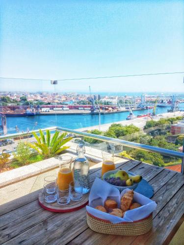 a table with a tray of food and drinks on a balcony at Great Apartment Belavista in Leça da Palmeira