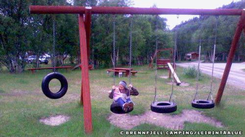 a person laying on the ground in a playground at Brennfjell Camping in Skibotn