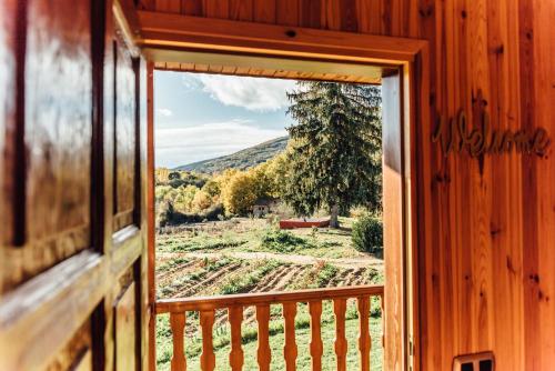 a window view of a farm from a house at Alojamiento Turístico La alegría de la huerta in Cepeda