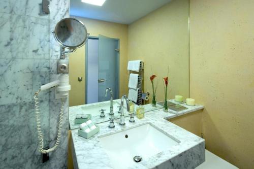a bathroom with a sink and a mirror at Hotel Penz West in Innsbruck