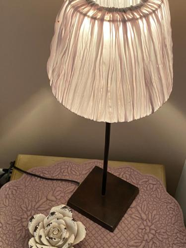 a lamp sitting on top of a bed at Mas Coeur Provence Calme Beauté Grand Parc in Pernes-les-Fontaines