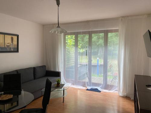 a living room with a couch and a large window at Ferienwohnung 1 - Gourmetzimmer in Bestensee