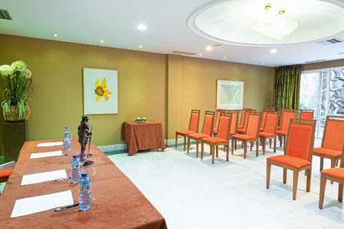 a conference room with a long table and chairs at Hotel Sancho in Madrid