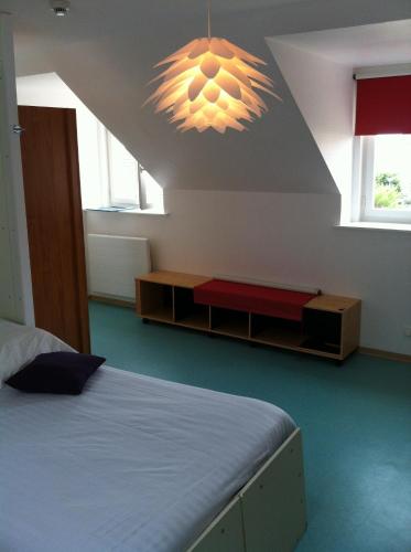 a bedroom with a bed and a chandelier at Hôtel Le Vivier WISSANT - Rivière in Wissant