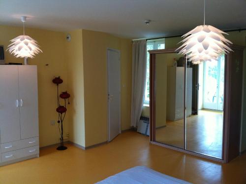 a room with two chandeliers and a mirror at Hôtel Le Vivier WISSANT - Rivière in Wissant
