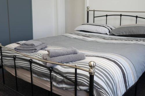 a bedroom with a bed with towels on it at Hullidays - University Side Lg 4 bed House in Hull