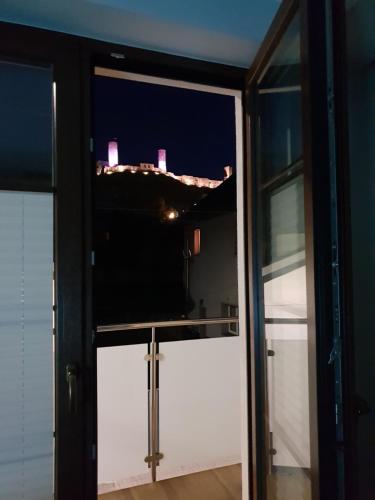 a view of the city from the balcony at night at Apartamenty Królewskie in Chęciny