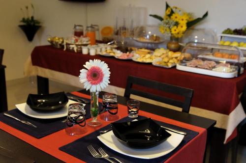 a table with two chairs and a buffet of food at B&B Alixia in Alezio