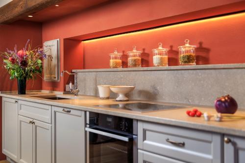a kitchen with a counter with jars on the wall at Villa La Massa in Bagno a Ripoli