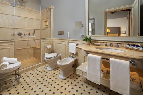 a bathroom with a toilet and a sink and a shower at Villa La Massa in Bagno a Ripoli