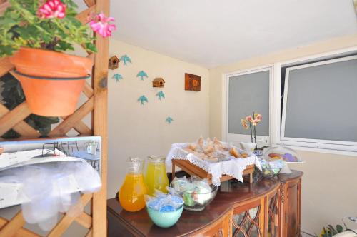 a kitchen with a table with food and a window at Porto Charming Hotel in Porto