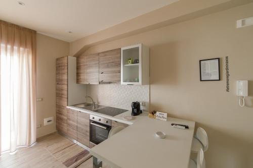 a kitchen with a sink and a counter top at Le Tre More in Giardini Naxos