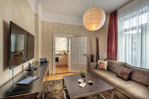 a living room with a couch and a table at Recknitztal-Hotel Marlow in Marlow
