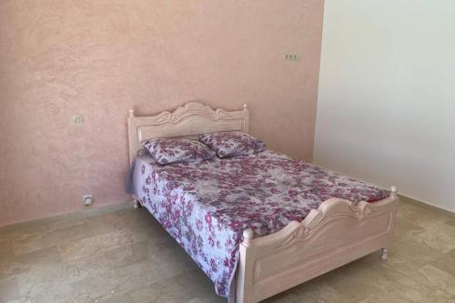 a bed with two pillows on it in a bedroom at Villa ChezMoi in Oulad Tayeb