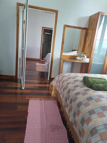 a bedroom with a bed and a mirror at One khaokho homestay in Khao Kho