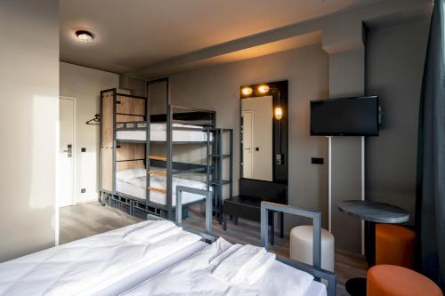 a bedroom with a bed and a bunk bed at a&o Budapest City in Budapest