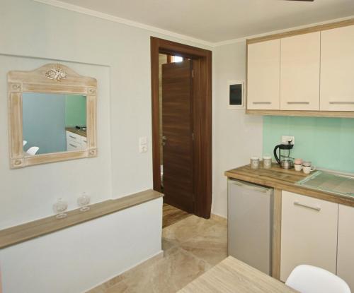 a kitchen with a counter and a mirror on the wall at Panos House in Koinyra