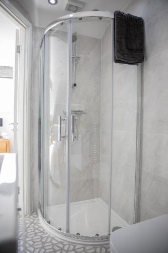 a shower with a glass door in a bathroom at The Old Bakery in Gateshead