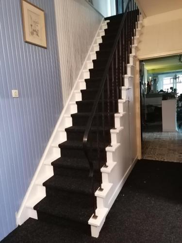 a black and white staircase in a house at Hotel B&B LeLa in Valkenburg