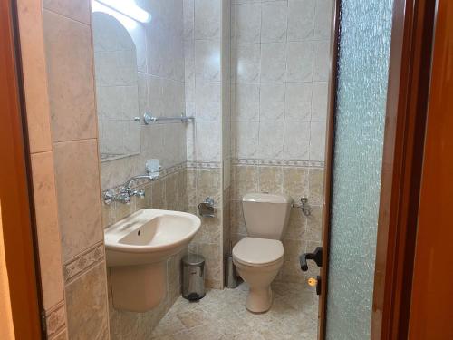 a bathroom with a toilet and a sink at Hotel Atanasov 1 in Primorsko