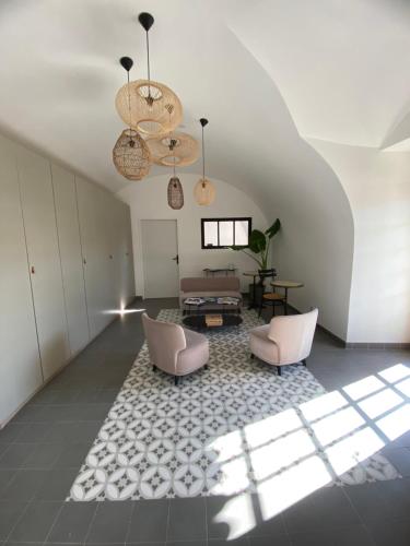 a living room with two chairs and a table at Auberge de la Tour de Brison in Sanilhac
