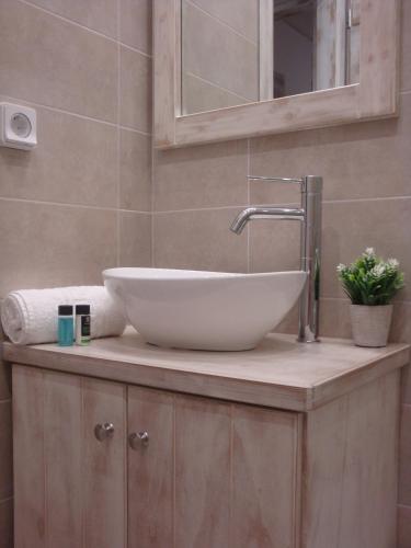 a bathroom with a white sink on a counter at 'Naxian family apartment' in Naxos Chora