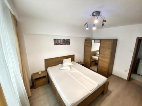 a bedroom with a large bed and a mirror at ”Modern Apartment” Old City Constanta in Constanţa
