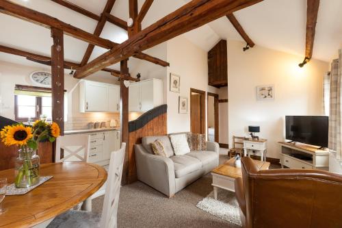 a living room with a couch and a table at Skipbridge Farm Cottages in Green Hammerton